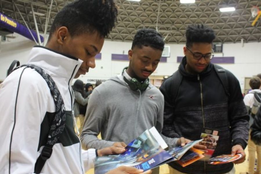 2019 CENTRAL HIGH SCHOOL COLLEGE FAIR-- Three seniors analyze brochures from their colleges of interest.