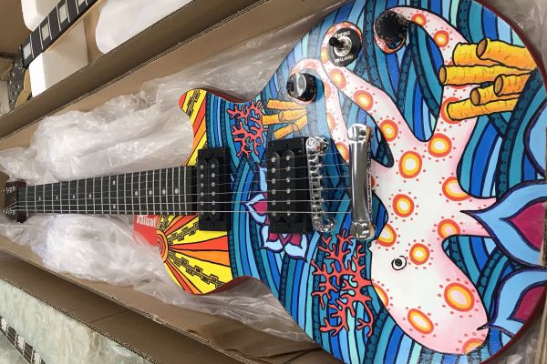 CENTRAL STUDENTS' GUITAR DESIGNS ARE ON DISPLAY IN DOWNTOWN CHATTANOOGA -- Competitor Danae Wnuk's guitar was inspired by sea life, as shown by the octopus depicted in her artwork.