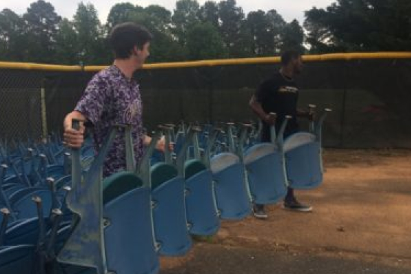 CENTRALS BASEBALL TEAM RECEIVES STADIUM SEATS TO IMPROVE STANDS -- Former and current players Cody Reels (left) and Michael McGhee (right) unload seats. 