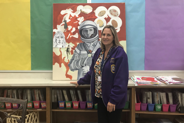 ART INSTRUCTOR MELISSA HOESMAN IS PAINTING THE PATHWAY FOR ARTISTIC NEW BEGINNINGS -- Ms. Hoesman is very excited to see what her new students can do. She models her latest art piece that centers around an astronaut.