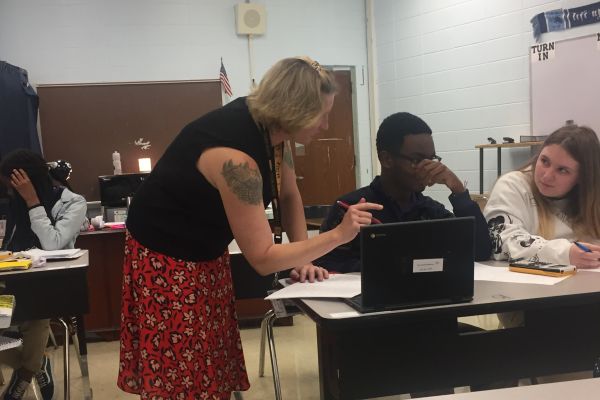 ALGEBRA I TEACHER DEE UNDERWOOD IS READY TO HELP STUDENTS REACH NEW HEIGHTS -- Here, Underwood helps out a student with work on their Chromebook.