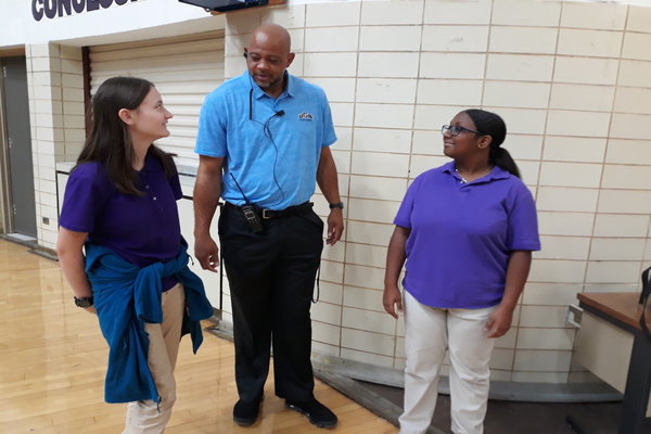 COACH DAVIS IS ENTHRALLED TO BE CENTRALS LATEST STUDENT DEAN -- Coach Davis bonds with freshmen, Gabby Roberts and Amaya Landess.