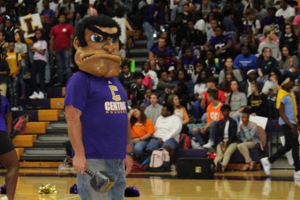 THE HISTORY OF STAN THE POUNDER MAN -- Christopher Kribs wears the "Stan the Pounder Man" head for the pep rally.