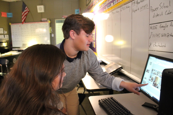 DYLAN MUCCINO TAKES THE 2020 CHAMPION YEARBOOK TO NEW LEVELS AS EDITOR IN CHIEF — Senior Dylan Muccino is pictured helping out a fellow Champion staff member.