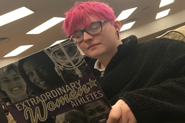 THE POSSIBILITY OF GIRLS' WRESTLING EXCITES CENTRAL STUDENTS --Marshall Sims reads about women in sports.