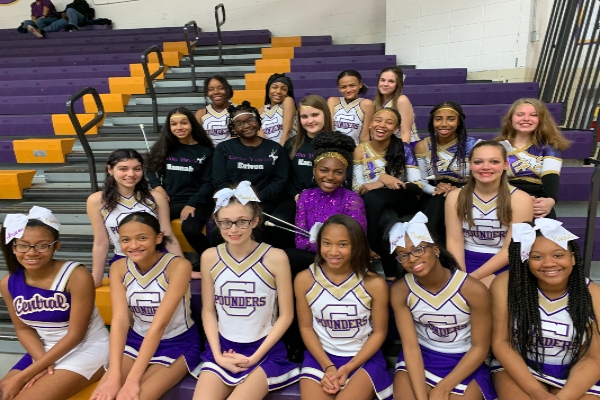 JUNIOR VARSITY CHEER SQUAD REVS UP POUNDER SPIRIT-- The junior varsity cheerleading team poses at a recent home basketball game.