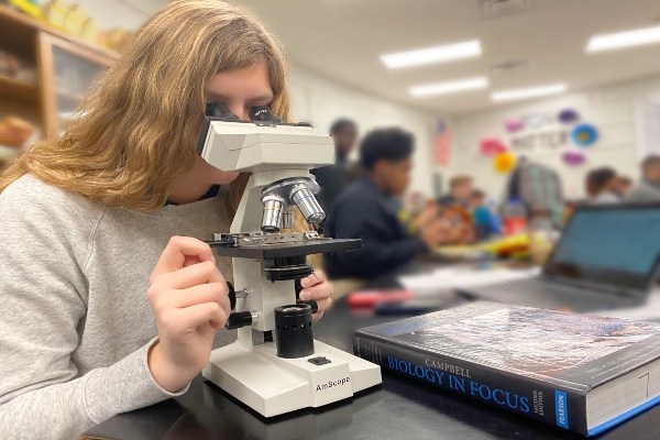 HAMILTON COUNTY JOINS STATE IN IMPROVING SCIENCE CURRICULUM AFTER LOW TEST SCORES --Senior Christina Harris observes a specimen under a microscope in Advanced Placement Biology.