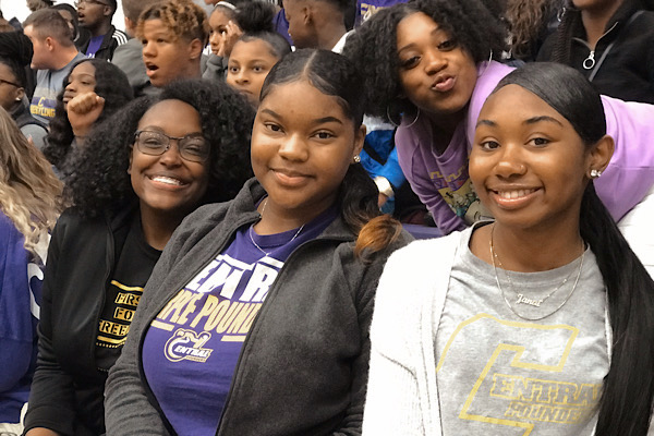 EDITORIAL: ARE SCHOOL HALF DAYS NECESSARY? -- Students are gathered at the pep rally. From left to right are Seniors Jahnia Russell, Khalia Shepard, and Janai Blakemore. At the top right is Senior Genesis Harris.