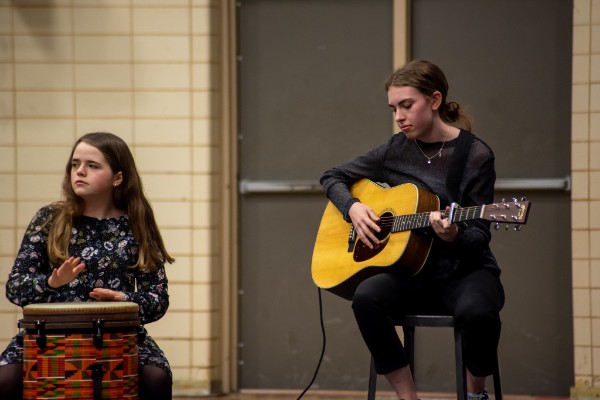 CENTRAL HIGH HOSTS STUDENT TALENT SHOW -- Anna Markstrom plays the guitar and Sarah Katheron Latham plays the African drums.