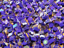 PROM, GRADUATION AND OTHER SENIOR EVENTS POSTPONED -- graduating students stand in their caps in gowns during their ceremony.