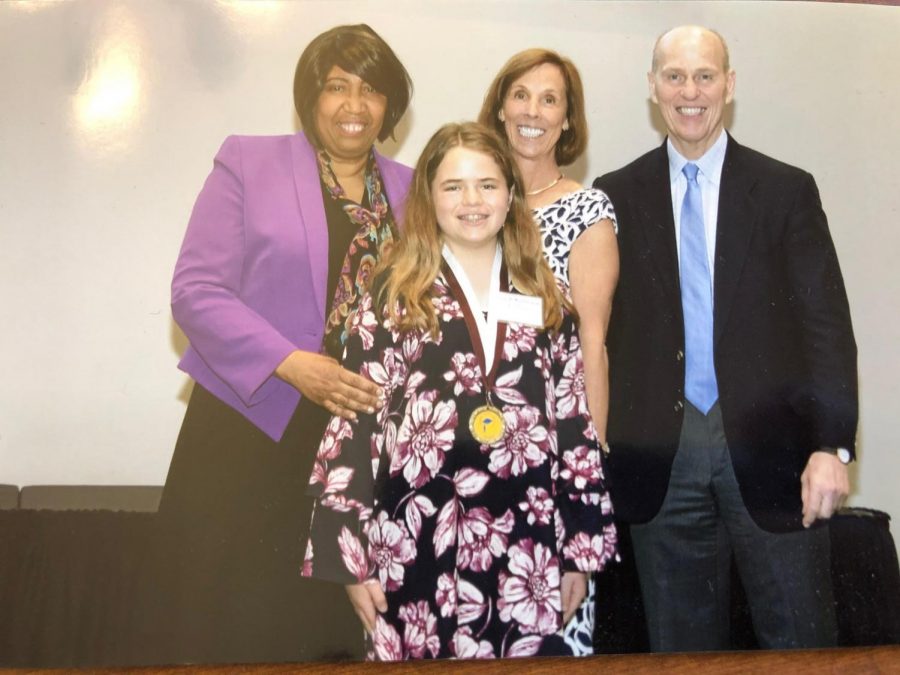 SARAH KATHERON LATHAM AND RILEY MARTIN ARE RECOGNIZED AS CARSON SCHOLARS -- Sarah Katheron Latham is honored with an official medal at the Carson Scholars banquet.