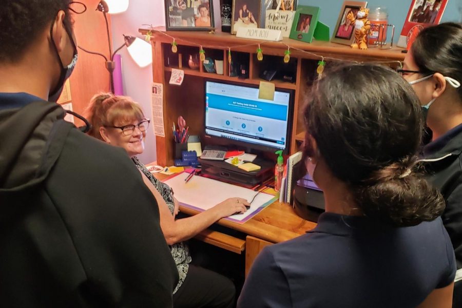 SENIORS MEET WITH COUNSELORS FOR FINAL SEMESTER HELP -- Stacy Alexander talks to three students about future testing protocol. File Photo from 2020.