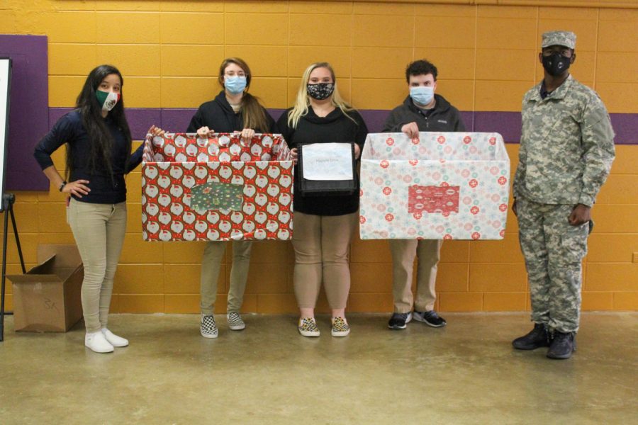 CENTRAL FOCUSES ON OUTREACH DURING A DIFFICULT YEAR-- Dallana Nolazco, Morgan Crites, Makayla Paris, Colby Adams, and Deondree Roberts stand in the armory with collection boxes for the toy and hygiene drives. 