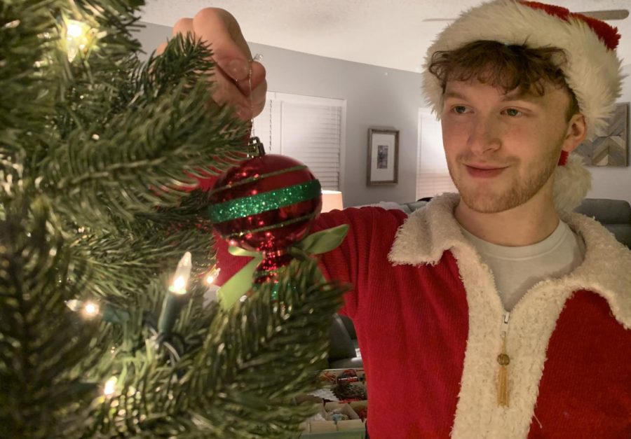 THE HOLI-GRAY SPECIAL-- Columnist Grayson Catlett decorates his familys Christmas tree.