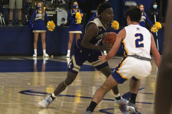 CENTRAL BOYS BASKETBALL SECURE WIN IN SEASONS FIRST HOME GAME -- Senior Brian Allen Jr. looks up for an open pass down the court. 