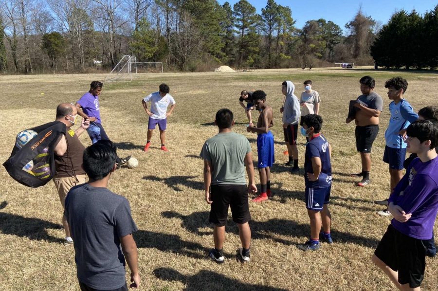 POUNDERS+PREPARE+FOR+2021+SOCCER+SEASON+--+Coach+Tim+Browder+and+Central+soccer+players+gather+before+they+start+practicing+to+discuss+their+goals.