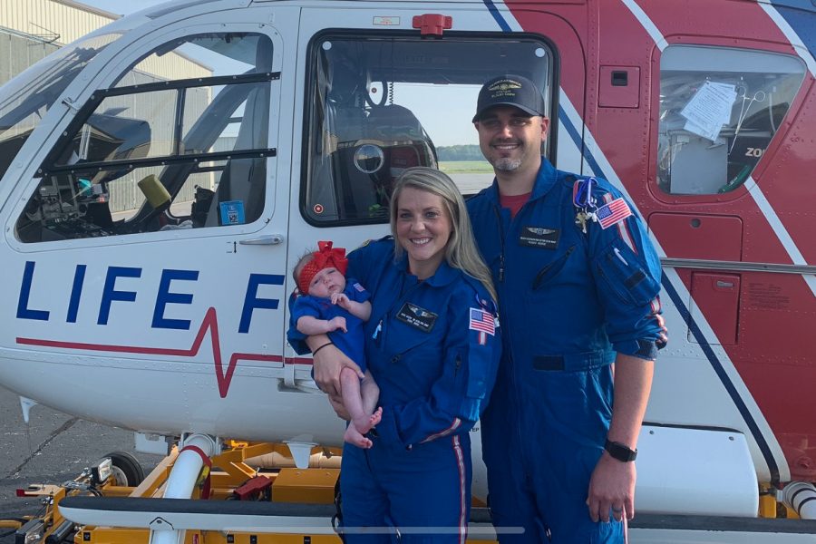 KARA (04) AND MARK (02) SERVE AS NURSES FOR LIFE FORCE -- The Eidsons stand in front of a LIFE FORCE helicopter with their daughter. 