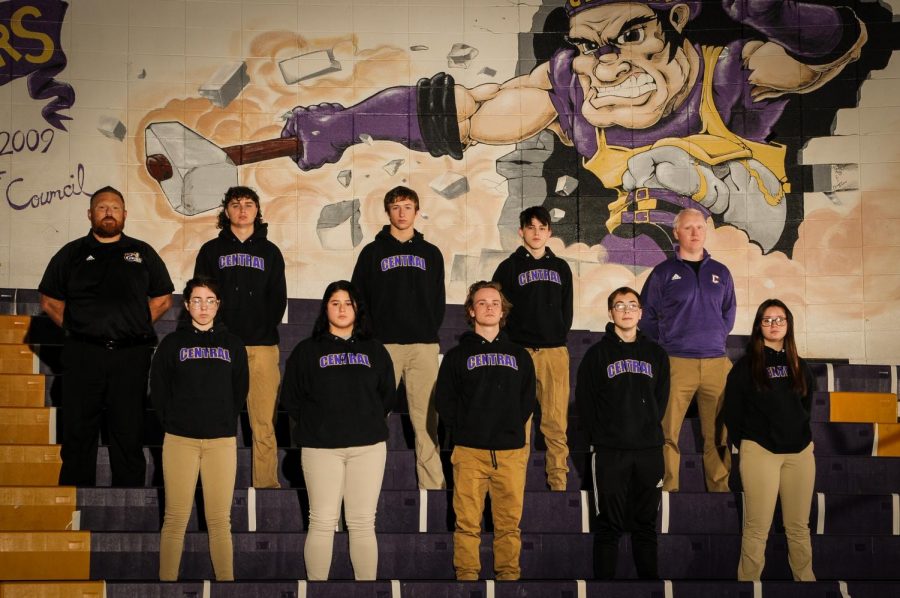 2020-21 WRESTLING WRAPS UP -- The wrestling team stands together in the gym. Top (left to right): Coach Ryan Mallory, Ethan Black, Brecken Griffith, Noah Pinion, Coach James Massengale. Bottom (left to right): Dahlia Frankel, Gabby Gray, Roby Thomas, Jaiden Hutton, Isabelle Moody.