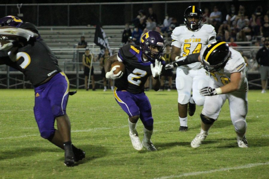 ITS A ROUT: FOOTBALL POUNDERS ROUT RIVAL WILDCATS; 40-0 -- Senior Noah Collins dodges Hixson defenders. 