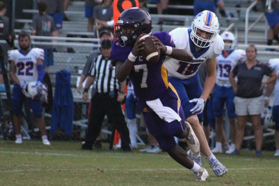 CENTRAL FOOTBALL WINS THEIR FIRST HOMECOMING GAME IN SEVEN YEARS -- Quarterback, Ronye Watson rolls out of the pocket and looks up for a pass. 