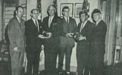 LOOKING BACK: 1962-1963 STUDENT COUNCIL OBTAINED THE FIRST SET OF AMERICAN FLAGS IN CLASSROOMS -- Russel Duggar and Principal H. Milsaps receive Bibles and American flags.