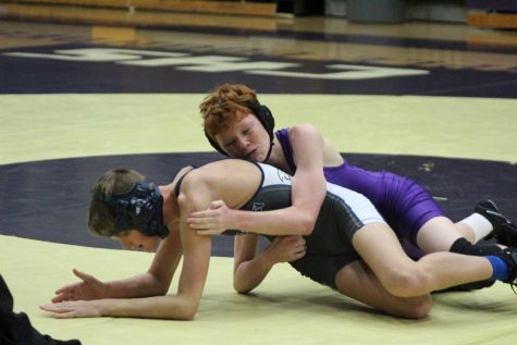 CENTRAL WRESTLING DOMINATES IN EARLY SEASON COMPETITION -- Sophomore Caleb Smith faces his opponent on the wrestling mat.