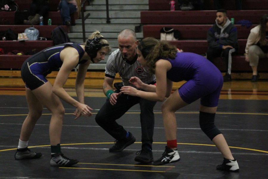 WRESTLING 2021-2022 SEASON GALLERY -- Freshman, Skyla Fowler in a stance staring into the eyes of her opponent.
