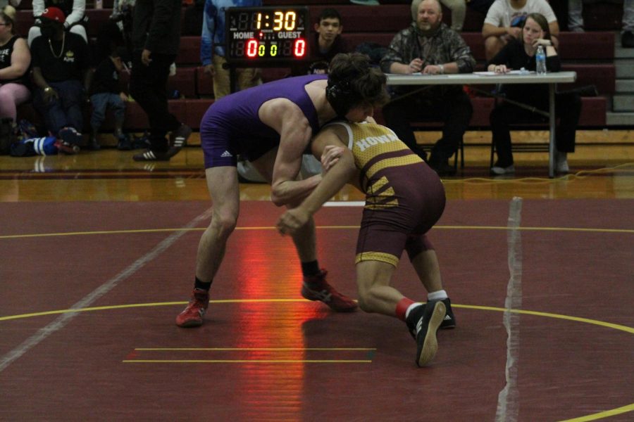 WRESTLING 2021-2022 SEASON GALLERY -- Junior, Cameron Hook pushes his opponent down to the mat.