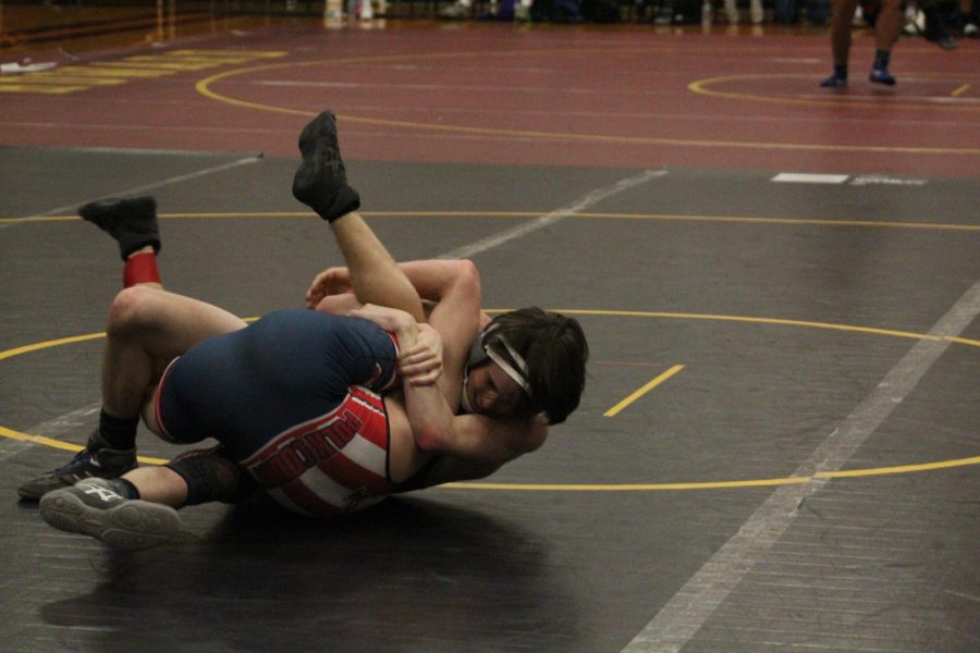 WRESTLING 2021-2022 SEASON GALLERY -- Senior, Noah Pinion attempts to pin his opponent with a spladle.