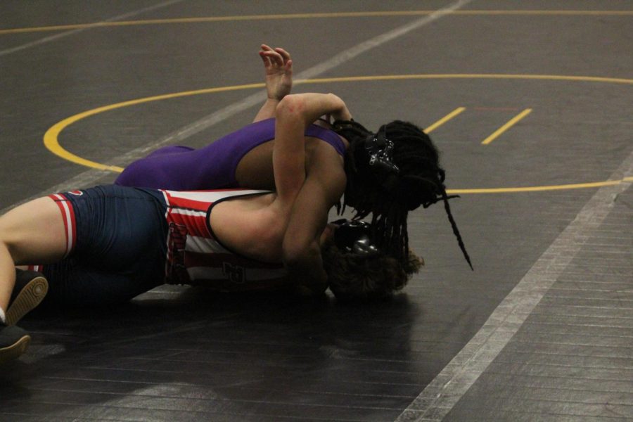 WRESTLING 2021-2022 SEASON GALLERY -- Junior, Kasan Parson pins his opponent on the mat for a win.
