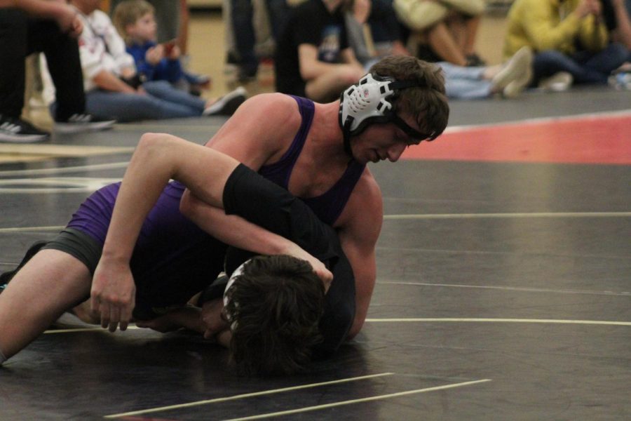 WRESTLING 2021-2022 SEASON GALLERY -- Junior, Randall Gray works to turn his opponent over for a pin.