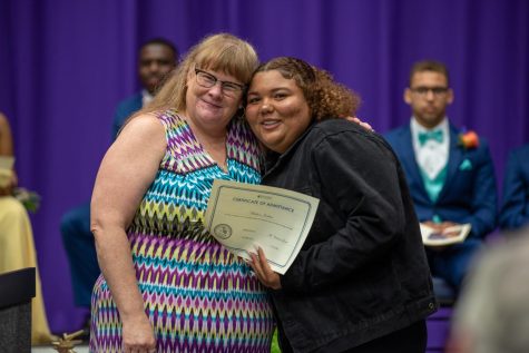 Mrs. Alexander standing with senior, after having given them their scholarship.